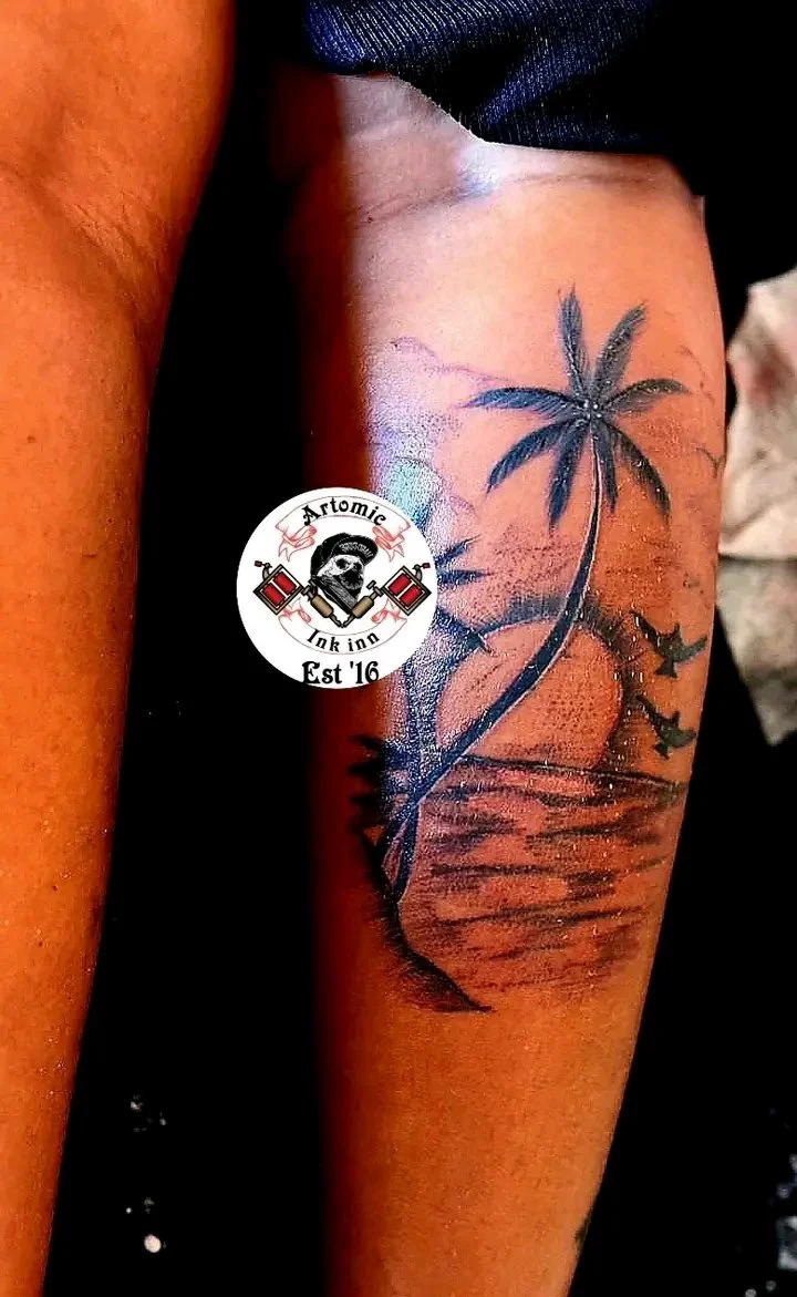 Color realism tropical palm tree sunset landscape tattoo on forearm