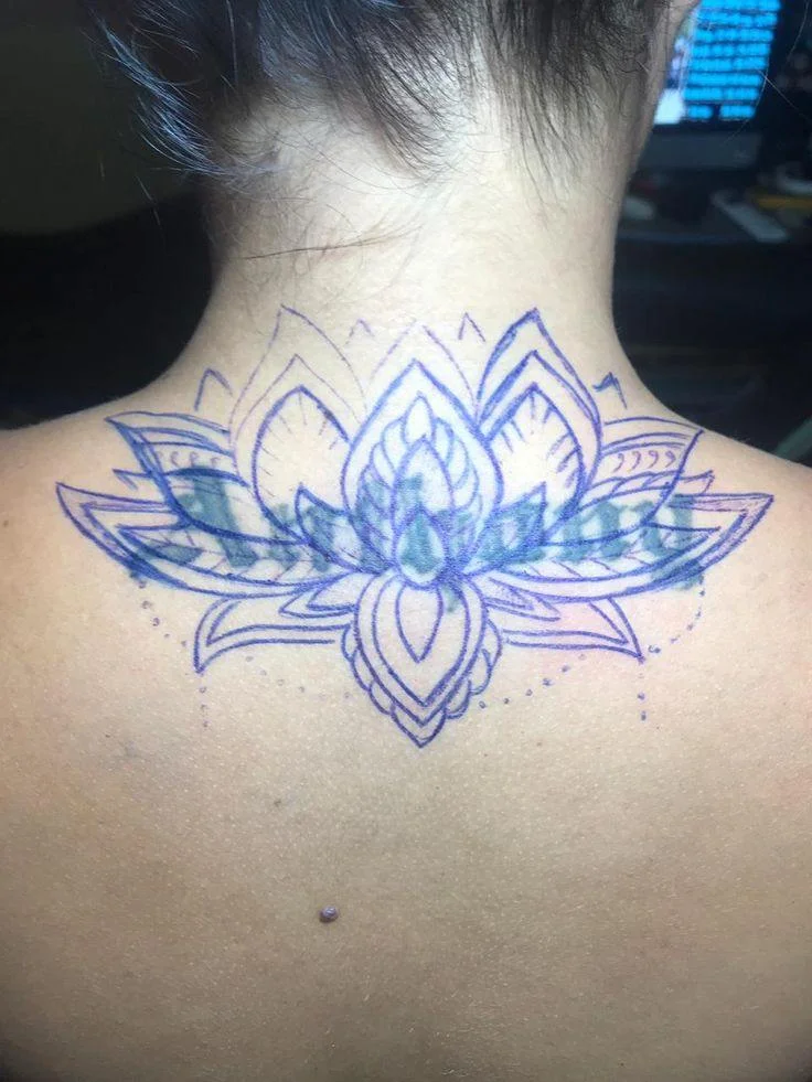 Blue ornamental lotus flower mandala tattoo on upper back